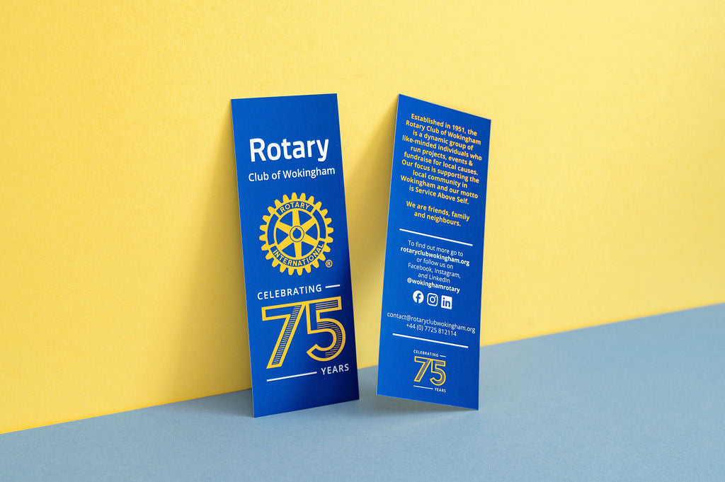 Two blue bookmarks celebrating the Rotary Club of Wokingham's 75th anniversary on a yellow and blue background.