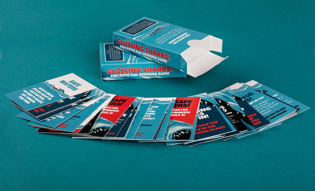 a fan of shark cards on a blue-green table