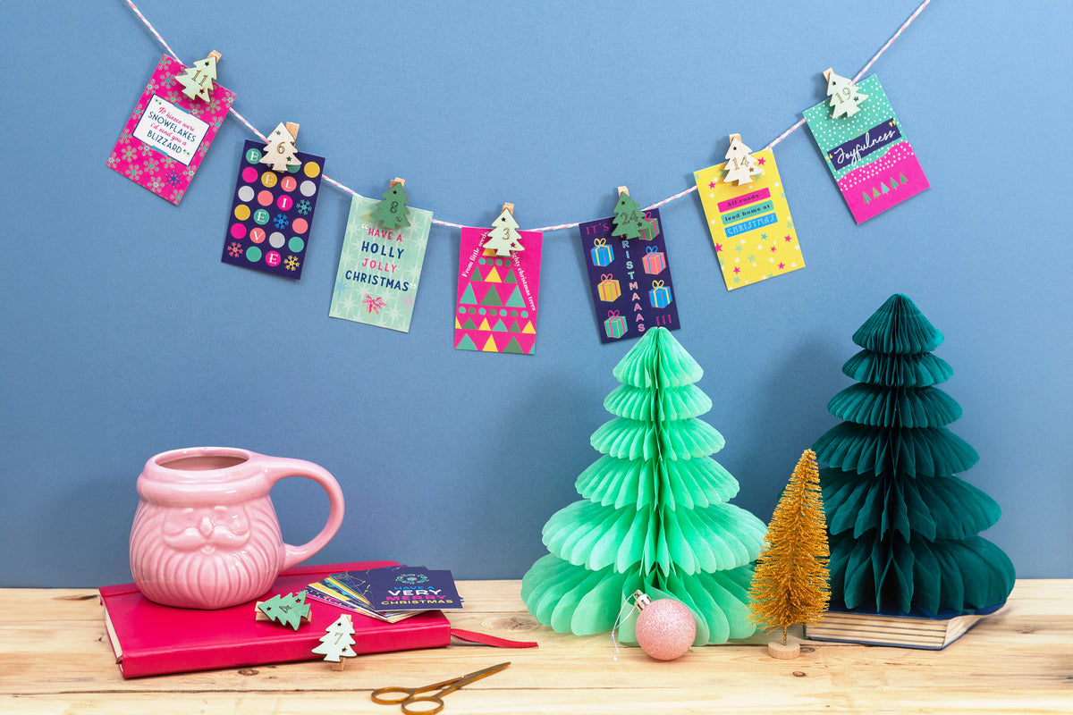 Christmas decorative quote cards hanging like bunting about paper Christmas tress