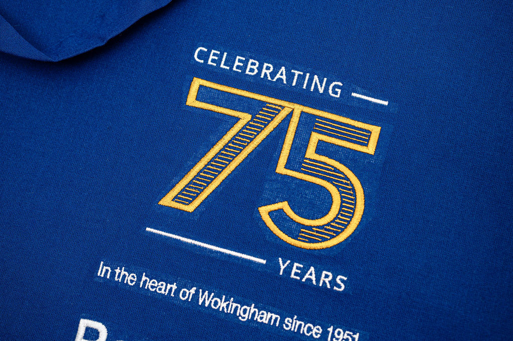 Blue bag with gold and white text celebrating 75 years in Wokingham