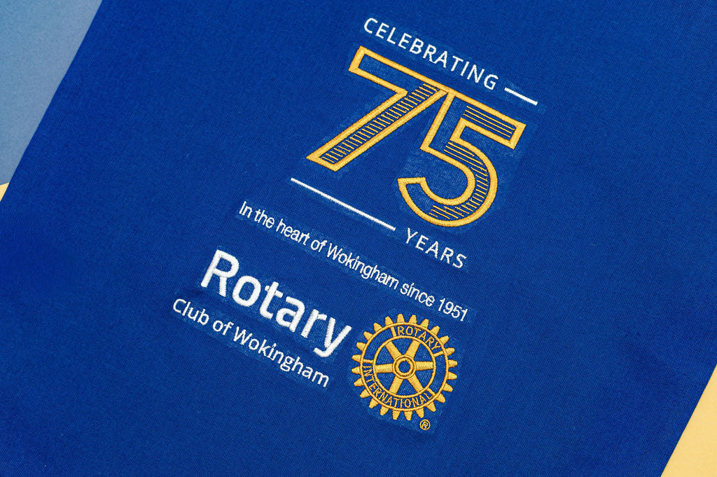Blue bag with yellow and white text celebrating 75 years of Rotary Club of Wokingham.