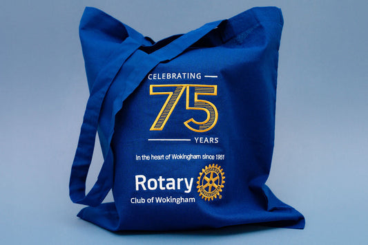 Blue tote bag celebrating 75 years of Rotary Club of Wokingham on a light blue background