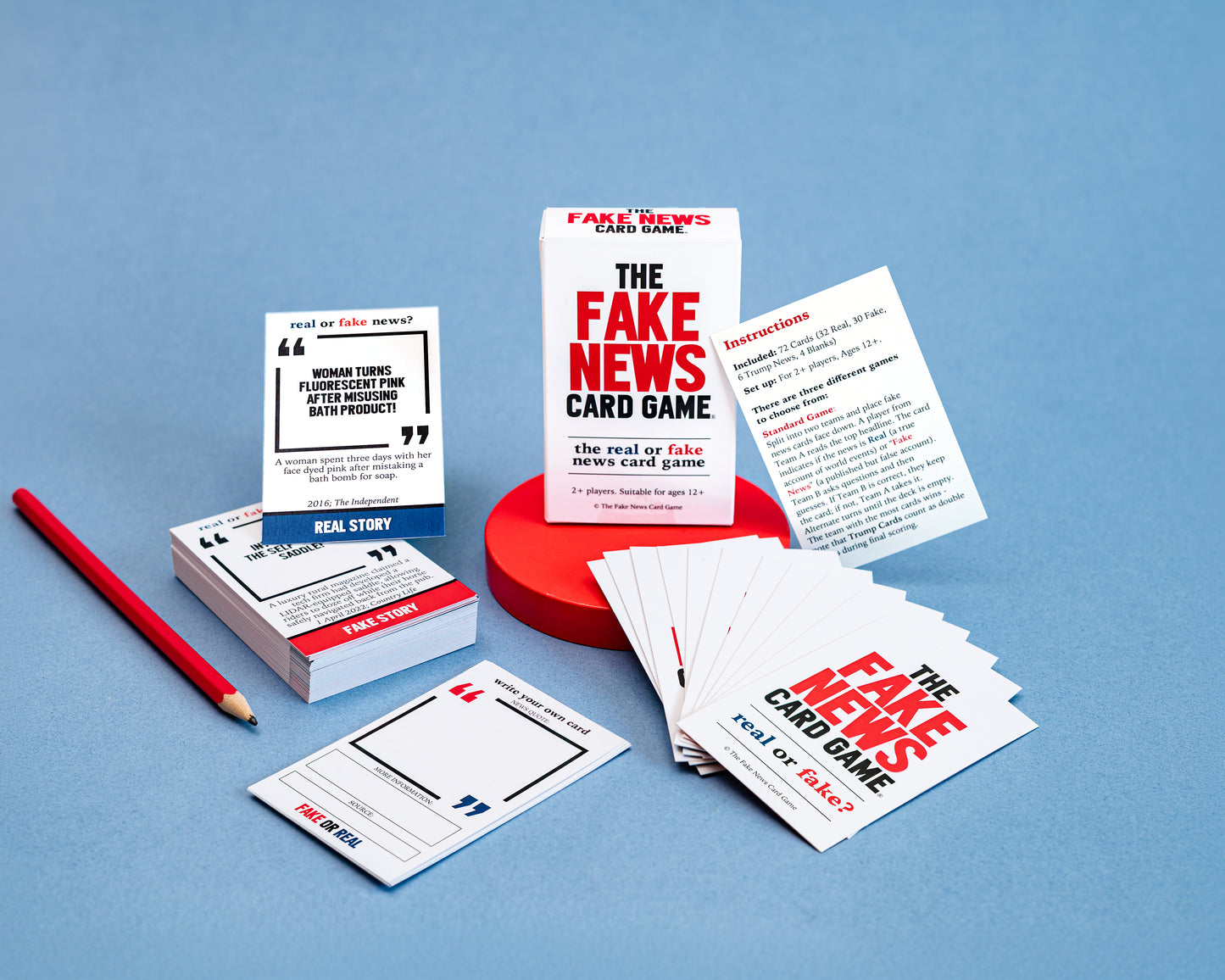 Fake News Card Game packaging and cards on a blue background