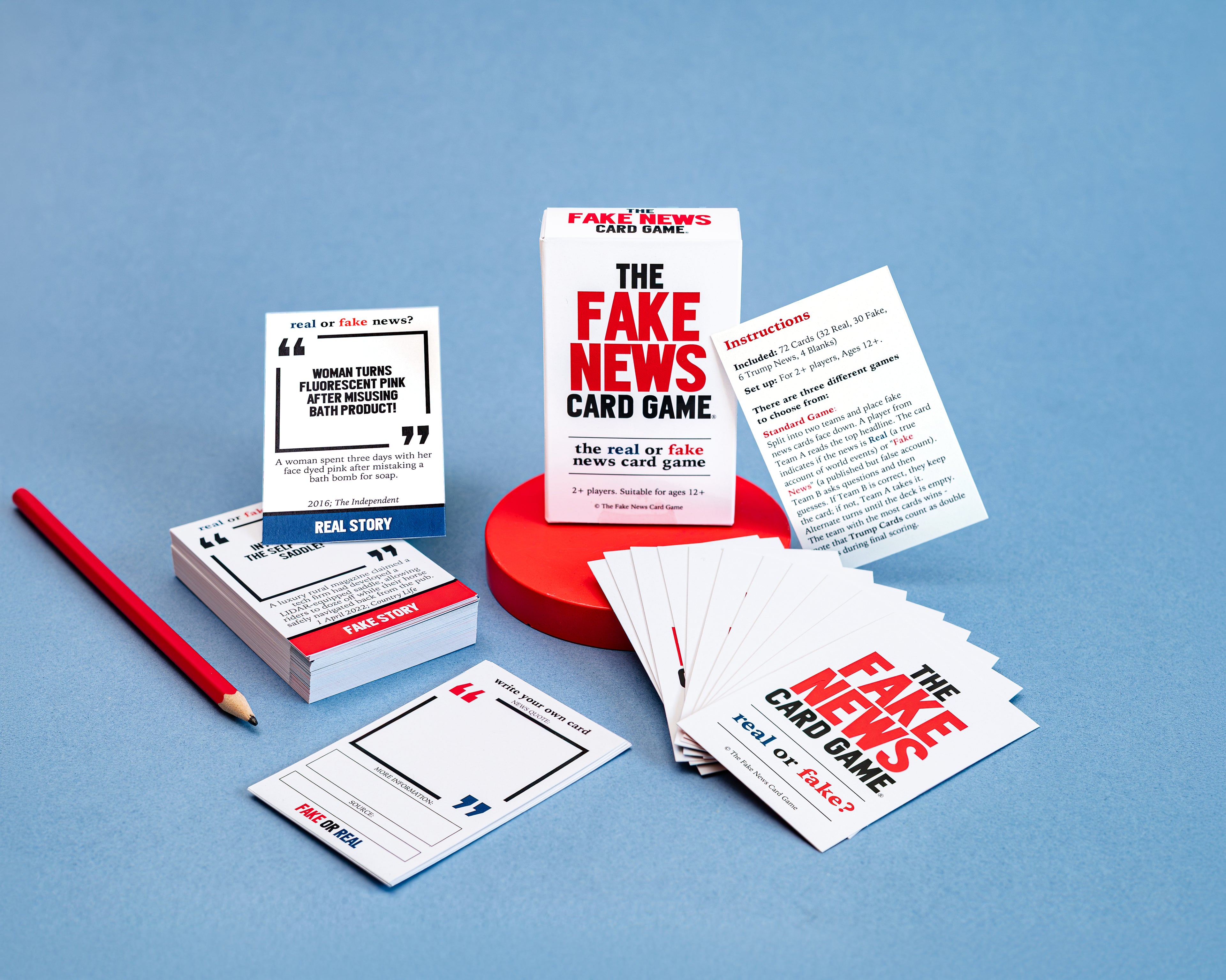 Fake News Card Game packaging and cards on a blue background