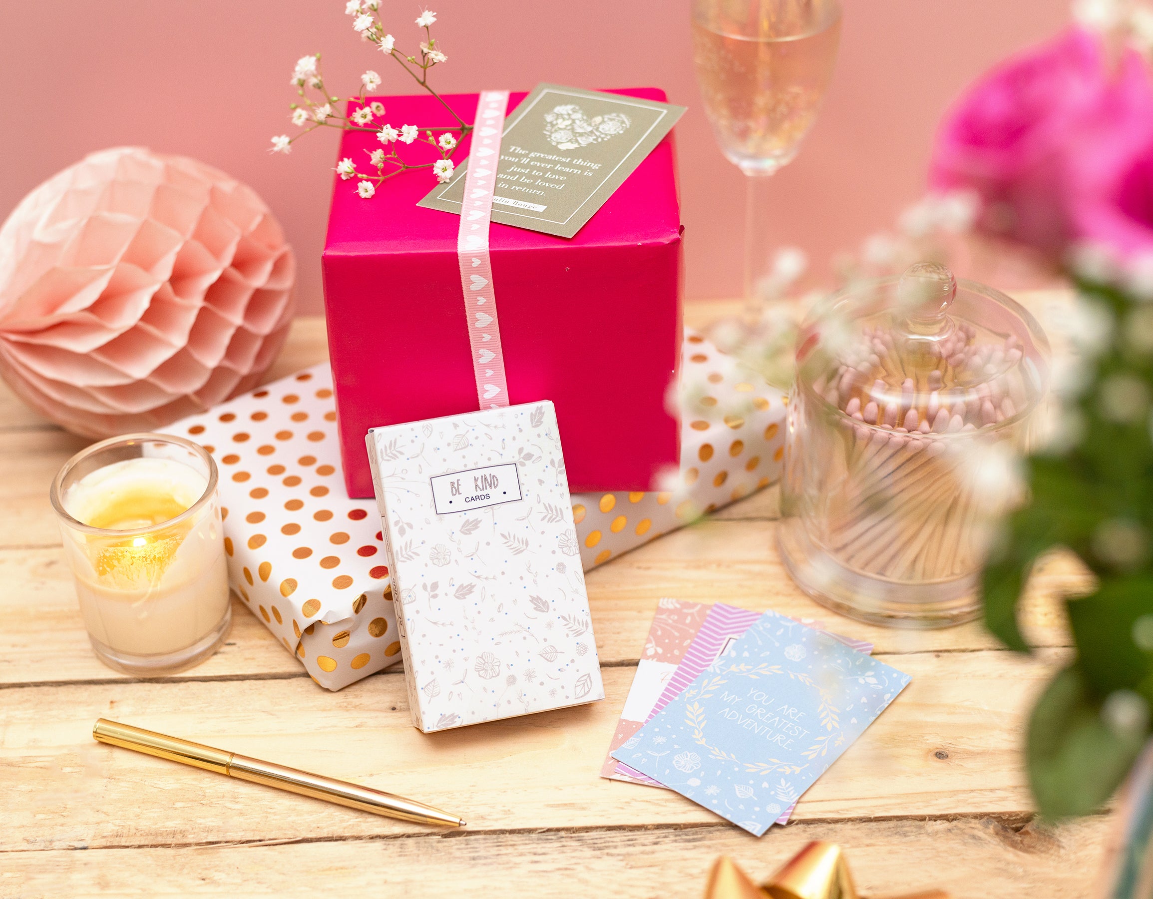Gift box with decorative items on a wooden surface